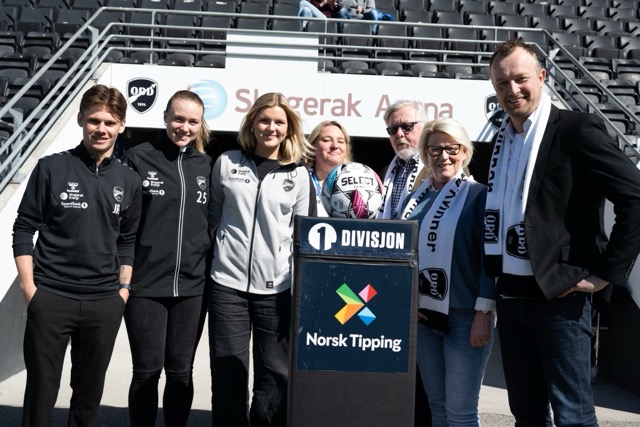 Gutter og jenter som står rundt en fotball