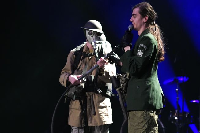 Mange unge står på en scene.